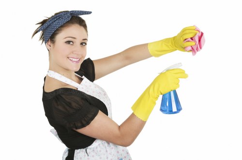 Cleaner wearing PPE while operating carpet cleaning equipment